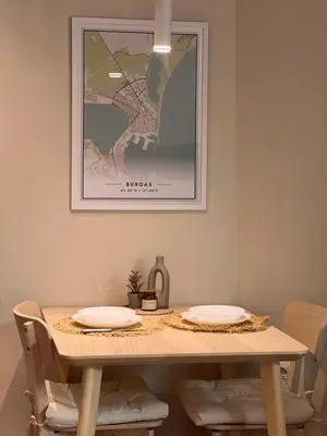 a dining room table with two plates on it at Lazur Beach Residence - 10min walk to beach in Burgas City