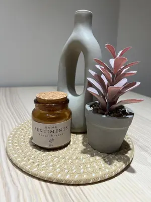 a jar of honey next to a potted plant and a vase at Lazur Beach Residence - 10min walk to beach in Burgas City