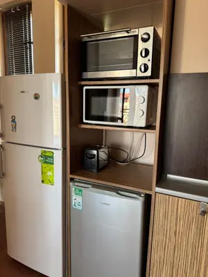 a kitchen with a microwave and a refrigerator at VP Pacific 2 in Sunny Beach