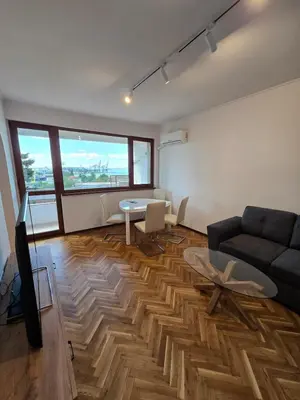 a living room with a couch and a table at Super Lovely Apartment in Burgas City
