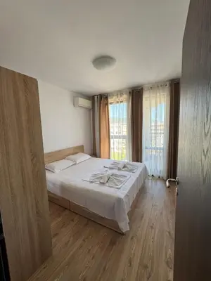 a bedroom with a bed and a large window at VP Morski Briag in Sveti Vlas