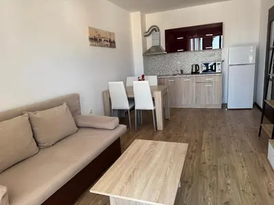 a living room with a couch and a kitchen at VP Morski Briag in Sveti Vlas