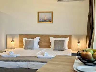 a bedroom with a large bed with two pillows at Sea View Allure Studio with Balcony in Primorsko