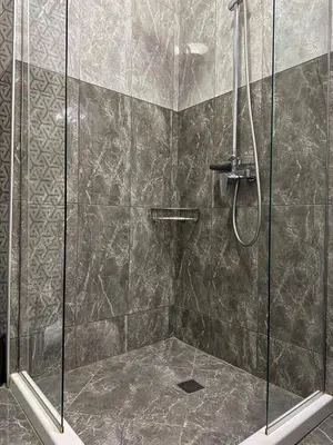 a bathroom with a shower with a glass door at Sea View Allure Studio with Balcony in Primorsko