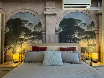 a bedroom with a large bed with three arches at Sea Garden Escape - Byala in Byala