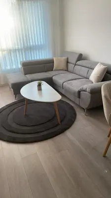 a living room with a couch and a coffee table at Сарафово Family in Burgas City