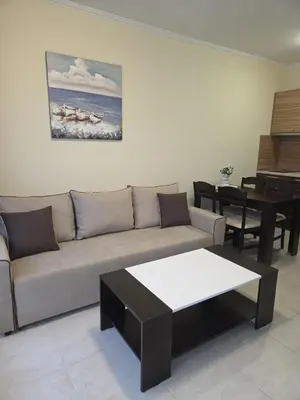 a living room with a couch and a table at Marina Park OLIWIA in Sveti Vlas