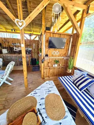 a living room with a table and a tv in a cabin at Каравана Coco Bongo in Chernomorets
