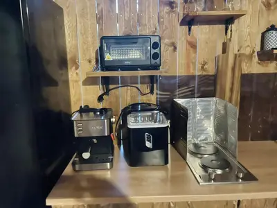 a kitchen counter with a microwave and a television at Каравана Coco Bongo in Chernomorets