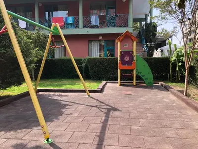 a playground in front of a house at Jasmine - Menada Apartments in Sunny Beach