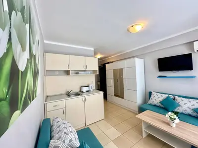 a small apartment with a kitchen and a living room at Jasmine - Menada Apartments in Sunny Beach