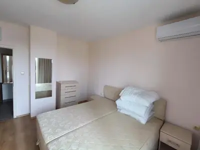 a white bedroom with a bed and a dresser at PSB Apartment in Flores park in Sunny Beach
