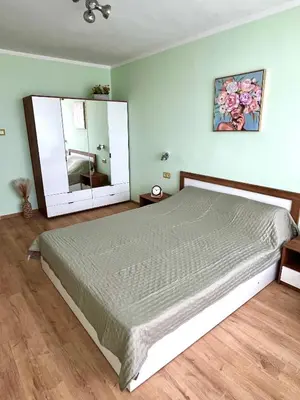 a bedroom with a large bed and a large mirror at PanoramaView Lazur in Burgas City