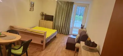 a small room with a bedroom with a bed and a table at Charming 2-bed Apartment with AC, 5 Mins from Beach in Sunny Beach