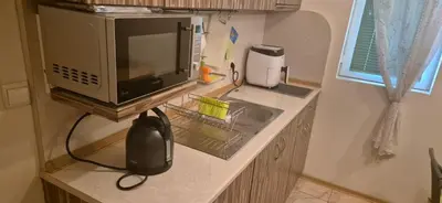 a kitchen counter with a microwave and a sink at Charming 2-bed Apartment with AC, 5 Mins from Beach in Sunny Beach