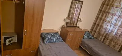 a bedroom with two beds and a dresser and curtains at Charming 2-bed Apartment with AC, 5 Mins from Beach in Sunny Beach