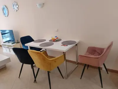 a table and chairs in a room with a television at 2 Room Apartment with Poolview Royal Sun in Sunny Beach