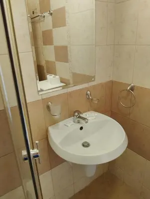a bathroom with a white sink and a mirror at 2 Room Apartment with Poolview Royal Sun in Sunny Beach