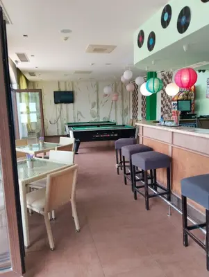 a restaurant with tables and chairs and a pool table at 2 Room Apartment with Poolview Royal Sun in Sunny Beach