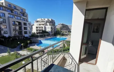 a balcony with a view of a pool and buildings at Sorrento Sole Mare Sveti Vlas in Sveti Vlas