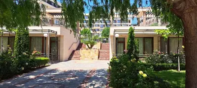 a house with a staircase in front of a building at Sorrento Sole Mare Sveti Vlas in Sveti Vlas