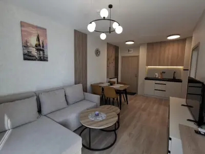 a living room with a couch and a table at Sorrento Sole Mare Sveti Vlas in Sveti Vlas