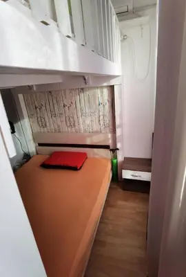 a small room with a bunk bed with a red pillow at Family Studio flat in Tŭnkovo