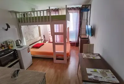 a small room with a bunk bed and a desk at Family Studio flat in Tŭnkovo