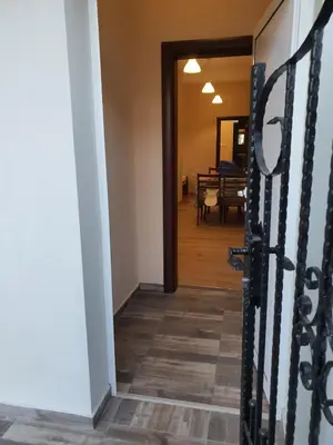 a hallway leading to a dining room with a table at Студио Морски бриз in Pomorie