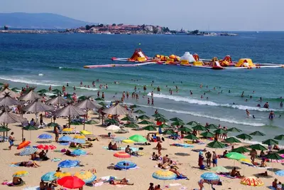 a group of people on a beach with umbrellas at VIGO Nessebar in Nesebar