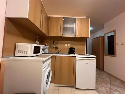 a small kitchen with a microwave and a dishwasher at VIGO Nessebar in Nesebar