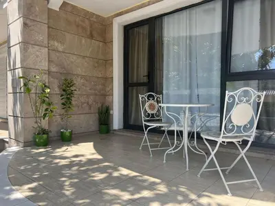 two chairs and a table on a patio at Villa ROMA apartaments&SPA in Nesebar
