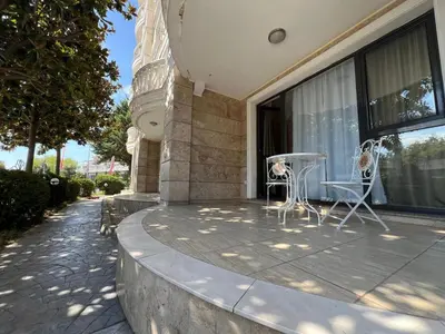 a patio with two chairs and a table on a building at Villa ROMA apartaments&SPA in Nesebar