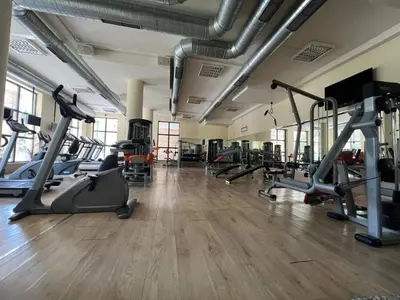 a gym with several treadmills and exercise bikes at Villa ROMA apartaments&SPA in Nesebar