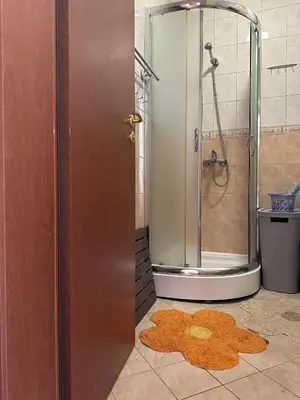a bathroom with a shower and a rug on the floor at Passat12 in Sunny Beach