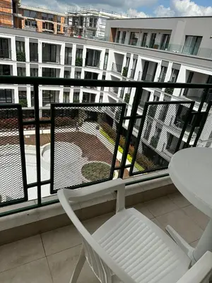a balcony with a table and chairs and a building at Passat12 in Sunny Beach
