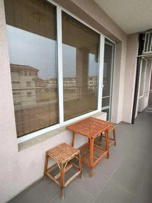 a pair of benches sitting next to a window at Adagio Sarafovo in Burgas City