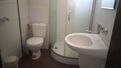 a small bathroom with a toilet and a sink at Adagio Sarafovo in Burgas City