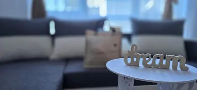 a white table in a living room with a couch at Divine place Pomorie in Pomorie