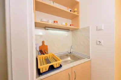 a small kitchen with a sink and a sink at Lazur Studio in Burgas City