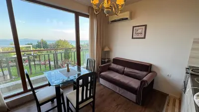 a living room with a couch and a table at Апартамент Панорама, двустаен, малък, първа линия, гледка море, DIAMOND BEACH, Сарафово in Burgas City