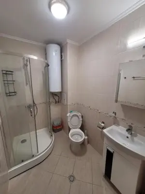 a bathroom with a shower and a toilet and a sink at Famagusta Antoniya in Aheloy