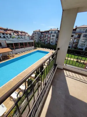 a balcony with a swimming pool and some buildings at Famagusta Antoniya in Aheloy