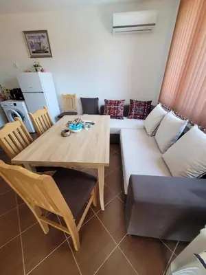 a living room with a table and a couch at Famagusta Antoniya in Aheloy