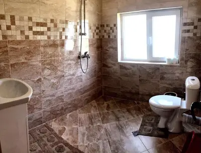 a bathroom with a shower and a toilet and a sink at Вила НАДЕЖДА in Byala