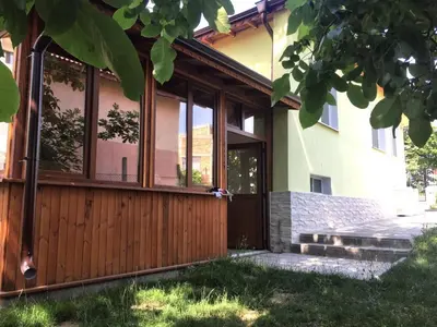 a house with a wooden front door and windows at Вила НАДЕЖДА in Byala