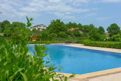 a large swimming pool with blue water at Azur Properties ap51 in Shkorpilovtsi