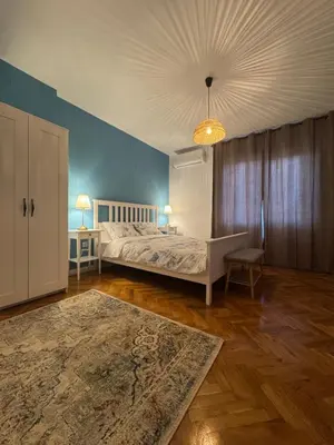 a bedroom with a bed and a blue wall at Studio by the sea in Primorsko