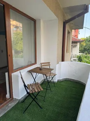 a table and two chairs sitting on a balcony at Studio by the sea in Primorsko