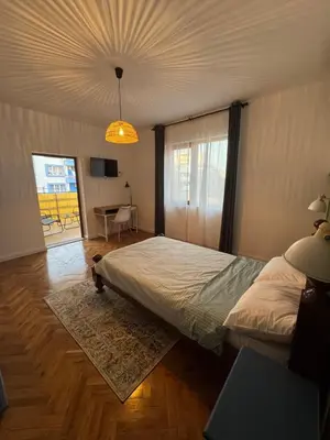 a bedroom with a large bed and a chandelier at Studio by the sea in Primorsko